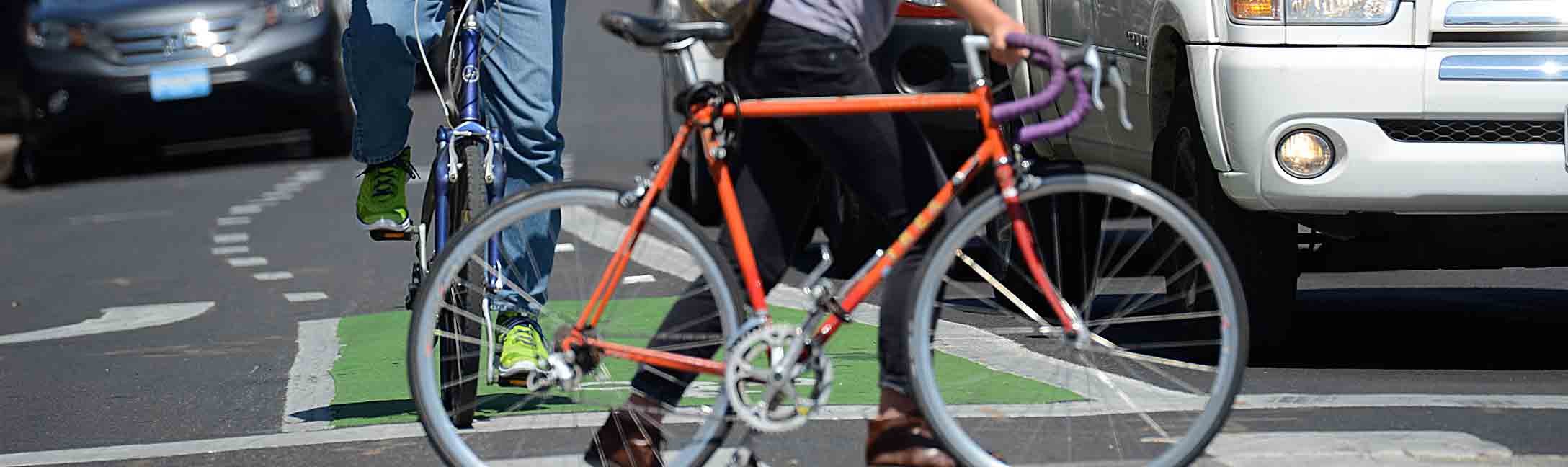 Bicycle in crosswalk, anoter waiting in bike lane