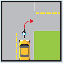 Bicycle rider turning right at an intersection or driveway.